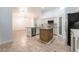 Open-concept kitchen with stainless steel appliances, a large island, and views into the living space at 4014 Trapani Pl, Las Vegas, NV 89141