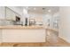 Spacious kitchen with stone countertops, stainless steel appliances, an island, and a breakfast bar at 4014 Trapani Pl, Las Vegas, NV 89141