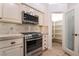 Gourmet kitchen featuring stainless steel appliances, custom cabinets, and a walk-in pantry at 4014 Trapani Pl, Las Vegas, NV 89141