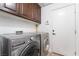 Functional laundry area with modern washer and dryer, painted walls, and convenient access from inside the house at 4014 Trapani Pl, Las Vegas, NV 89141