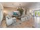 Bright, open living room with tile floors, neutral furniture, and modern chandelier at 4014 Trapani Pl, Las Vegas, NV 89141