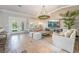 Bright open concept living space featuring tile floors, french doors, and comfortable neutral colored furnishings at 4014 Trapani Pl, Las Vegas, NV 89141