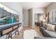Inviting living space featuring a gray sectional, large TV, and sliding mirrored closet for a modern appeal at 4014 Trapani Pl, Las Vegas, NV 89141