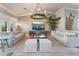 Open living room boasts tile floors, two large sofas, a stylish chandelier, and a tv at 4014 Trapani Pl, Las Vegas, NV 89141