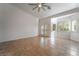 Spacious living room with tile flooring, neutral paint, large windows with shutters, and double doors at 4014 Trapani Pl, Las Vegas, NV 89141