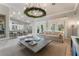 Expansive living room showcases an open floor plan, kitchen bar, modern lighting, and neutral decor at 4014 Trapani Pl, Las Vegas, NV 89141
