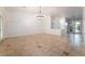 Bright living room with tile flooring, stylish lighting fixture and direct access to front entry and patio at 4014 Trapani Pl, Las Vegas, NV 89141