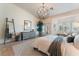 The main bedroom is bright and open with shutters, doors to the outside, and a decorative chandelier at 4014 Trapani Pl, Las Vegas, NV 89141