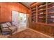 Office area with cozy chair and beautiful built-in bookcase with decorative books at 4014 Trapani Pl, Las Vegas, NV 89141