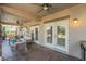 Covered patio with comfortable seating, ceiling fans, and neutral colors, ideal for outdoor relaxation at 4014 Trapani Pl, Las Vegas, NV 89141