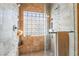Tiled shower with a built-in bench, shower products nook, a shower head and a frosted glass block window at 4014 Trapani Pl, Las Vegas, NV 89141