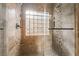 Tiled shower with stone accents, built-in shelves, glass block window and dual shower heads at 4014 Trapani Pl, Las Vegas, NV 89141