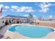 Backyard view showcasing the pool and the house with solar panels on a sunny day at 4414 E Baltimore Ave, Las Vegas, NV 89104