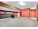 Spacious basement with gray carpet, exposed wood beam, black accent wall, and red accent wall at 4414 E Baltimore Ave, Las Vegas, NV 89104