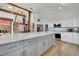 Modern kitchen featuring stainless steel appliances, a spacious island, and a cozy living area with a fireplace at 4414 E Baltimore Ave, Las Vegas, NV 89104