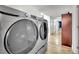 Laundry room with side-by-side washer and dryer and wood-look flooring at 4414 E Baltimore Ave, Las Vegas, NV 89104