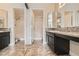 Dual vanity bathroom with tiled floors, granite counters, and shower at 5162 S Jones Blvd # 108, Las Vegas, NV 89118