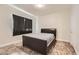 Simple bedroom with dark curtained window, tile floors, and neutral walls at 5162 S Jones Blvd # 108, Las Vegas, NV 89118