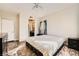 Cozy bedroom featuring a ceiling fan, a window, and a glimpse of the bathroom at 5162 S Jones Blvd # 108, Las Vegas, NV 89118