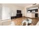 Living room includes sofa, coffee table, and TV, open to the kitchen with appliances at 5162 S Jones Blvd # 108, Las Vegas, NV 89118