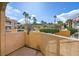 A private patio with a satellite dish offers a scenic view of the pool area and palm trees at 5162 S Jones Blvd # 108, Las Vegas, NV 89118