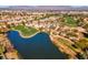 Community aerial view showcasing a pond adjacent to a golf course at 5305 La Patera Ln, Las Vegas, NV 89149