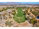 A scenic aerial of a golf course with mature trees and surrounded by residences at 5305 La Patera Ln, Las Vegas, NV 89149