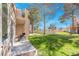 The private covered patio sits adjacent to a green space perfect for relaxation and entertaining at 5305 La Patera Ln, Las Vegas, NV 89149