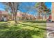 Scenic backyard view of a grassy lawn offering a serene and open space for various outdoor activities at 5305 La Patera Ln, Las Vegas, NV 89149