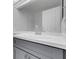 Bathroom vanity has a white countertop, gray cabinets, and a faucet with a white sink at 5305 La Patera Ln, Las Vegas, NV 89149