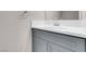 Bathroom features a stylish gray vanity with solid surface countertop and modern chrome faucet at 5305 La Patera Ln, Las Vegas, NV 89149