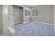 Neutral bedroom with carpet and natural light showcasing an open closet and sunny windows at 5305 La Patera Ln, Las Vegas, NV 89149