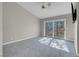 Bedroom with vaulted ceiling, carpet, fan and slider to the outside at 5305 La Patera Ln, Las Vegas, NV 89149