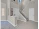 Bright foyer with stairs and tile flooring leads to the living spaces at 5305 La Patera Ln, Las Vegas, NV 89149