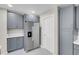 Kitchen featuring stainless steel refrigerator, gray cabinets, pantry, and recessed lighting at 5305 La Patera Ln, Las Vegas, NV 89149