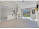 Open living room featuring a cozy fireplace and a sliding glass door at 5305 La Patera Ln, Las Vegas, NV 89149