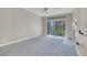 Neutral living room with sliding door access and a decorative fireplace at 5305 La Patera Ln, Las Vegas, NV 89149