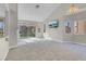 Spacious living room with natural light and modern chandelier at 5305 La Patera Ln, Las Vegas, NV 89149