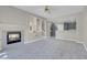 Spacious living room features a fireplace and open access to the kitchen and stairs to the second floor at 5305 La Patera Ln, Las Vegas, NV 89149
