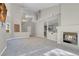 Bright, open-concept living room with fireplace, high ceilings, and modern lighting at 5305 La Patera Ln, Las Vegas, NV 89149