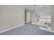 Upstairs loft area with neutral carpet and natural light coming in from windows at 5305 La Patera Ln, Las Vegas, NV 89149