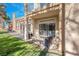 An outdoor patio features comfortable seating and a view of the manicured green lawn, perfect for relaxation at 5305 La Patera Ln, Las Vegas, NV 89149