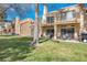 The back patio features outdoor seating and a barbecue grill overlooking a meticulously maintained grass lawn at 5305 La Patera Ln, Las Vegas, NV 89149