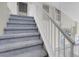 Carpeted staircase with white banister leads to the upper level of the home at 5305 La Patera Ln, Las Vegas, NV 89149