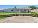 A single-story home with a green yard and open patio in the backyard at 5350 Topaz St, Las Vegas, NV 89120