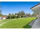 Well-manicured backyard with expansive lawn, hedges, and patio area at 5350 Topaz St, Las Vegas, NV 89120