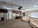 Basement featuring tan carpet, comfortable seating, kitchenette, and neutral decor, offers flexible living at 5350 Topaz St, Las Vegas, NV 89120