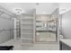 Luxurious primary bathroom features a walk-in shower, built-in shelves, and tile floors at 5350 Topaz St, Las Vegas, NV 89120