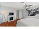 Bright bedroom features a ceiling fan, wood floors, and modern fireplace under a large Eiffel Tower print at 5350 Topaz St, Las Vegas, NV 89120