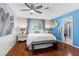 Bright bedroom with hardwood floors, a ceiling fan, and a blue accent wall at 5350 Topaz St, Las Vegas, NV 89120